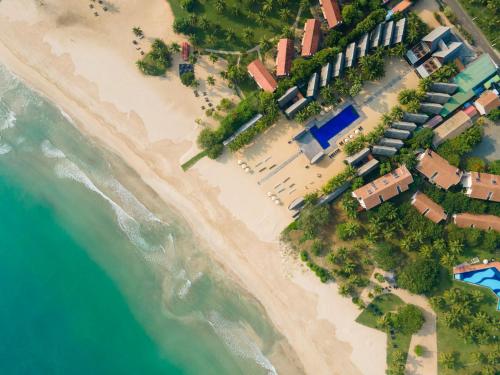 an overhead view of a beach with a resort at Maalu Maalu Resort & Spa - Thema Collection in Pasikuda