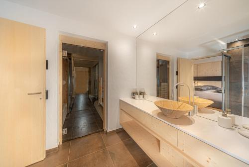 a bathroom with a counter with a sink and a mirror at Villa Carolina in Selva di Val Gardena