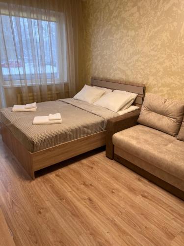 ein Bett und ein Sofa in einem Schlafzimmer in der Unterkunft Prisma Apartment in Tallinn