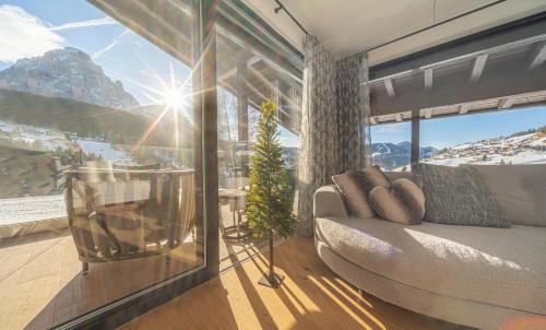 a bedroom with a bed and a view of a mountain at Villa Carolina in Selva di Val Gardena