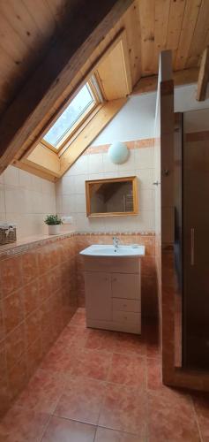 a kitchen with a sink and a skylight at Penzion Krakovice in Kaplice