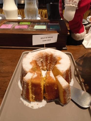 a cake sitting on a plate on a table at Silvestre Praia Hotel in Imbituba