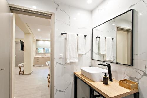 a bathroom with a sink and a mirror at Nina's House in Achladies