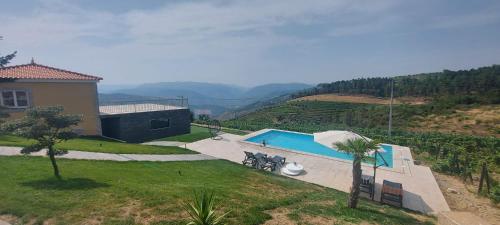 a house with a swimming pool on a hill at Quinta da Laceira - Douro Valley - Alojamento Local in Vila Real