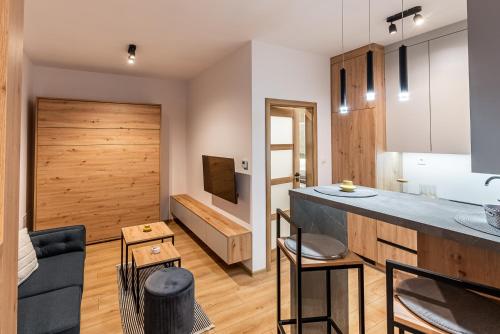 a kitchen and living room with a wooden door at One bedroom apartment in Dolný Kubín