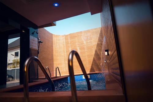 a view of a swimming pool through a window at Kawruky Hotel Benin in Benin City