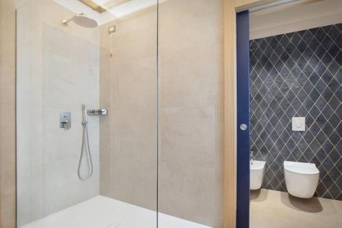a bathroom with a glass shower with a toilet at Villa Divina - APT Divina con piscina e vista lago in Castelletto di Brenzone