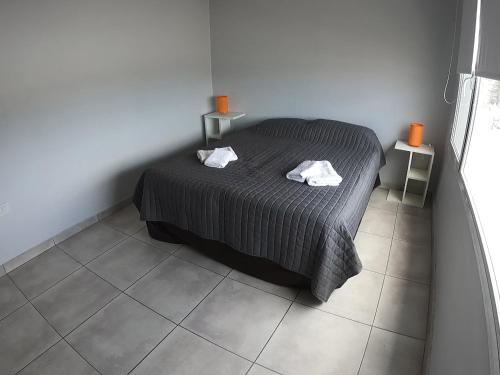 a bedroom with a bed with two towels on it at Buenos aires centro in Viedma