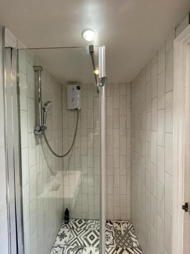 a bathroom with a shower with a glass door at Gateforth Flat-Lovely 1 Bed in the heart of Central London in London