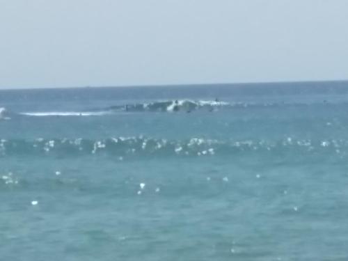 a surfer riding a wave in the ocean at Prasai House in Ahangama