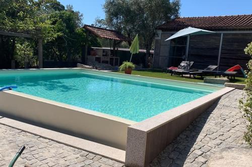 a swimming pool in the backyard of a house at Quinta do Tojal - Tourism immersed in nature! in Vila Maior