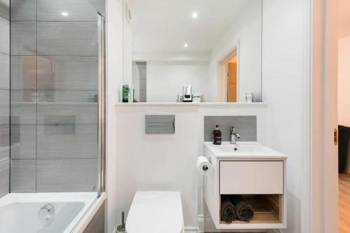 a bathroom with a toilet and a sink and a shower at Chapel View - Huge Apartment near the Beach with Gated Parking in Margate