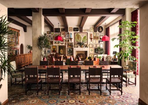 a living room with a large table and chairs at Graduate Palo Alto in Palo Alto