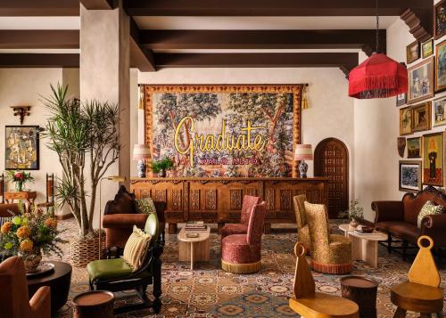 a lobby with furniture and a large tapestry at Graduate Palo Alto in Palo Alto