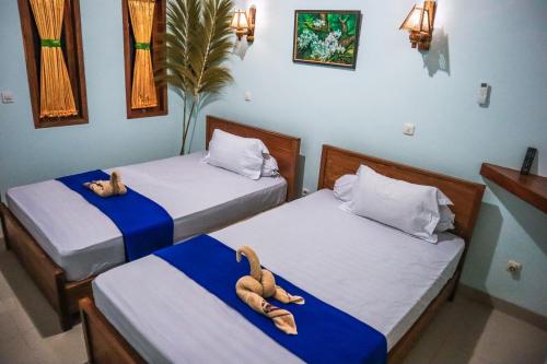 Ένα ή περισσότερα κρεβάτια σε δωμάτιο στο gery watukarung surfcamp