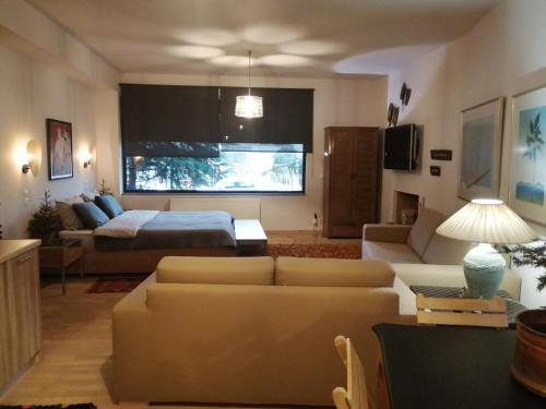 a living room with a couch and a bed at Lumen 1-bedroom apartment in the heart of Trikala in Tríkala
