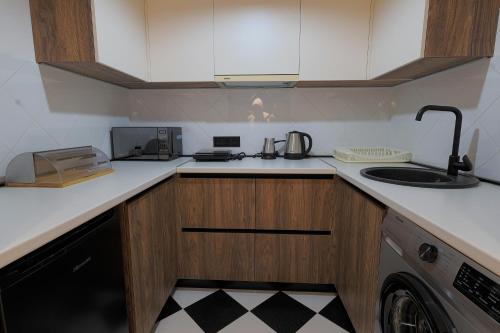 a kitchen with a sink and a counter top at Welcome Republic Square Apartments in Yerevan