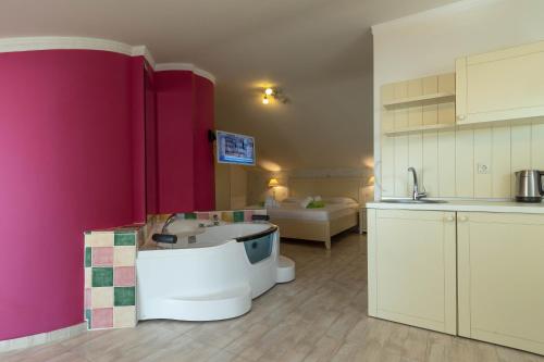 a kitchen with a tub in the middle of a room at Oniro Luxury Villas in Toroni