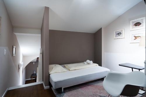a small bedroom with a bed and a chair at Altstadthotel Kasererbräu in Salzburg