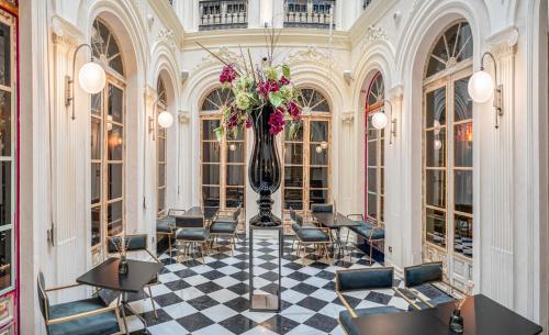 a lobby with a vase with flowers in it at Hotel Lobby in Seville