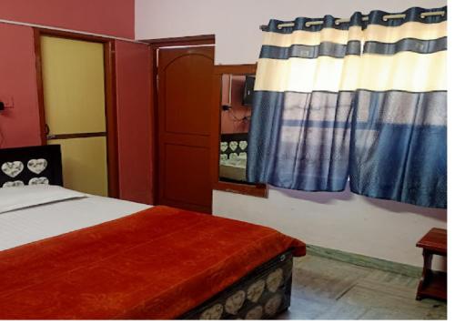 a bedroom with a bed and a window at Nandita S Beach Bay Rest House By WB Inn in Visakhapatnam