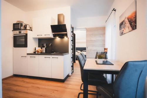 a kitchen and dining room with a table and chairs at Haus Österreich - Familie Digruber in Lackenhof