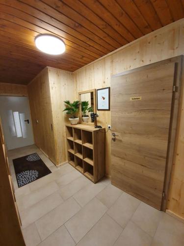 a room with a wooden door and a room with a table at Haus Österreich - Familie Digruber in Lackenhof