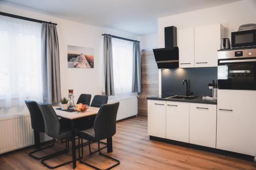 a kitchen and dining room with a table and chairs at Haus Österreich - Familie Digruber in Lackenhof