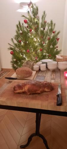 a table with a christmas tree and a table with food at Le Coq du Nord - Mailhac Gîte et Chambres d'Hôtes in Mailhac