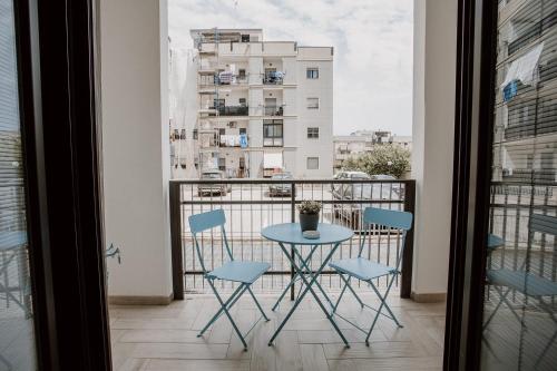 a table and chairs on a balcony with a view of a building at Marilu Vacanze in Bari Palese