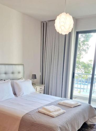 a bedroom with a bed with two towels on it at Ocean Pearl Apartment M in Funchal
