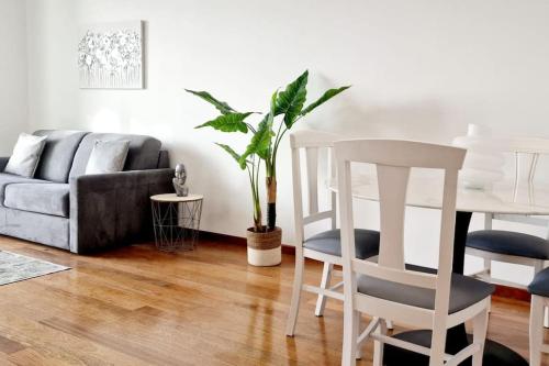 a living room with a couch and a table and chairs at Ocean Pearl Apartment M in Funchal