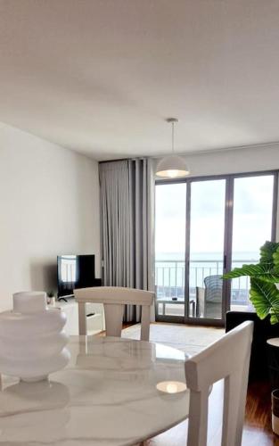 a living room with a table and chairs with a view at Ocean Pearl Apartment M in Funchal