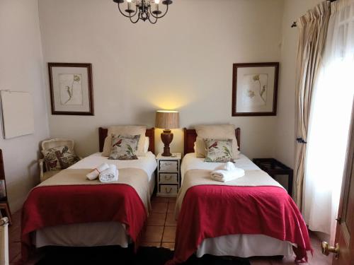 a bedroom with two beds with towels on them at DeKotzenhof in Wakkerstroom