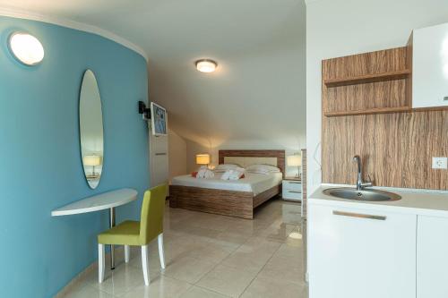 A bed or beds in a room at Oniro Luxury Villas