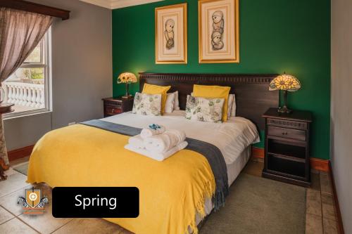 a bedroom with a bed with towels on it at All Seasons Boutique Hotel in Pretoria