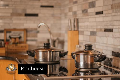 two metal pots on a stove in a kitchen at All Seasons Boutique Hotel in Pretoria