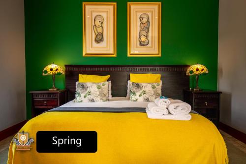 a bedroom with a yellow bed with green walls at All Seasons Boutique Hotel in Pretoria