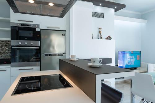 a kitchen with a island with a stove top oven at Oniro Luxury Villas in Toroni