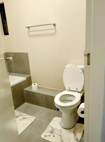 a bathroom with a toilet and a sink at Modern 2 bedroom at Waterfall Ridge-Midrand in Midrand