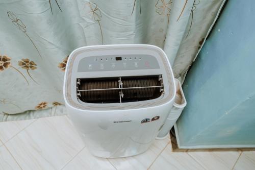 a toaster sitting on the floor next to a wall at Kisanga Homestay in Moshi
