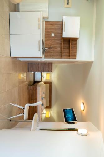 a kitchen with a laptop computer on a counter at Oniro Luxury Villas in Toroni