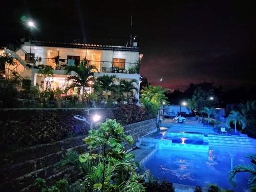 a house with a swimming pool at night at Casa de Robles Tanay Rizal in Tanay