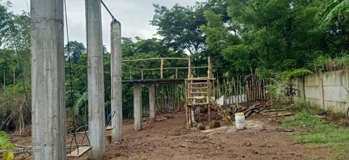 a wooden structure in the dirt next to a fence at Casa de Robles Tanay Rizal in Tanay
