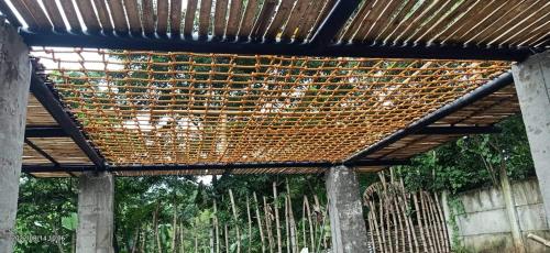 a wooden structure with a wooden roof over a fence at Casa de Robles Tanay Rizal in Tanay