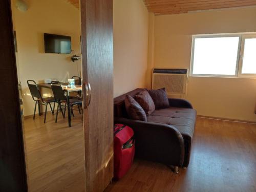 a living room with a couch and a table at Mary Apartment Gudauri Residence in Gudauri