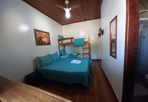 a bedroom with a bed and a bunk bed at Pousada Baía do Sol Vilatur in Saquarema
