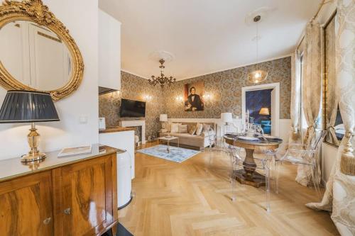 a living room with a table and a mirror at Schubert's Creative Luxury Haven in Vienna