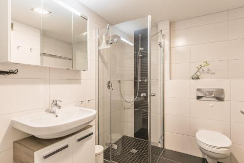 a white bathroom with a sink and a shower at "Ferienwohnug Bambergers" Ferienwohnung Bamberger s in Büsumer Deichhausen