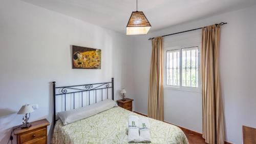 a bedroom with a bed and a window at Chalet Algar by Ruralidays in Algar